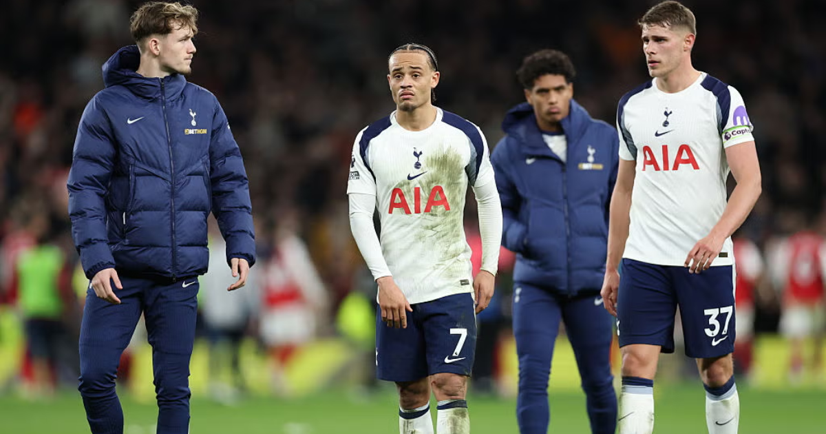 Tottenham Hotspur players, including Brennan Johnson and Micky van de Ven, walking off the pitch with dejected expressions during a match.
