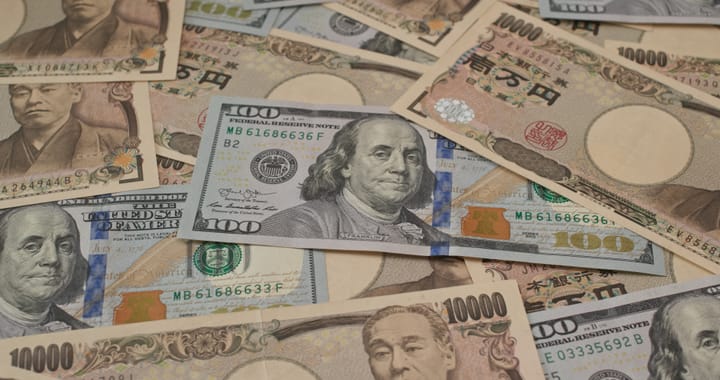 A scattered pile of Japanese 10,000 yen banknotes and United States 100 dollar bills overlapping each other.